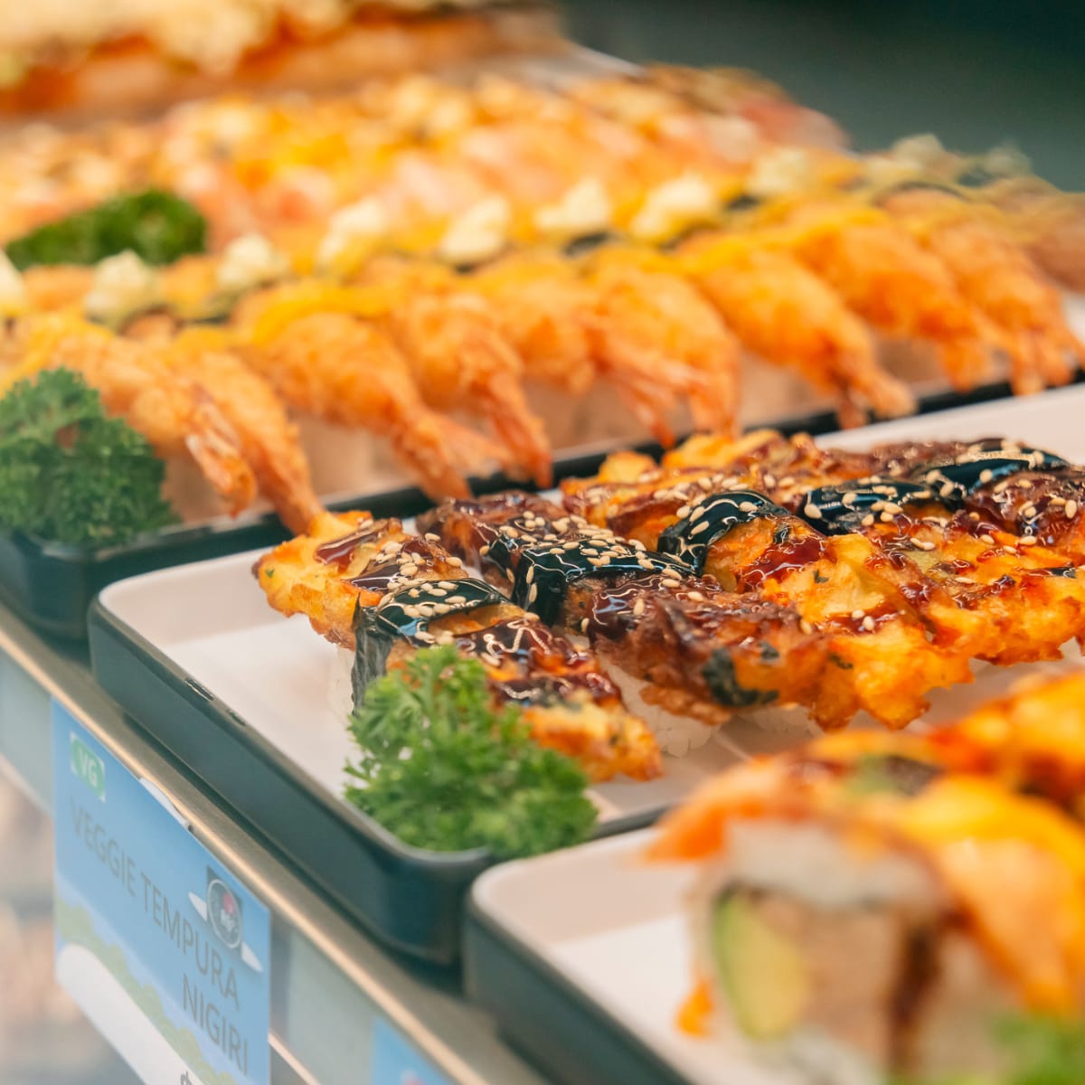 Sushi displayed in a cabinet.
