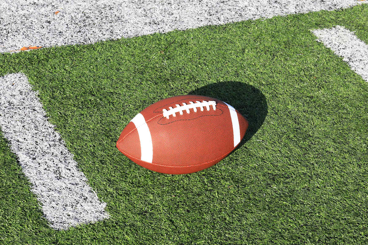 An American Football placed on turg