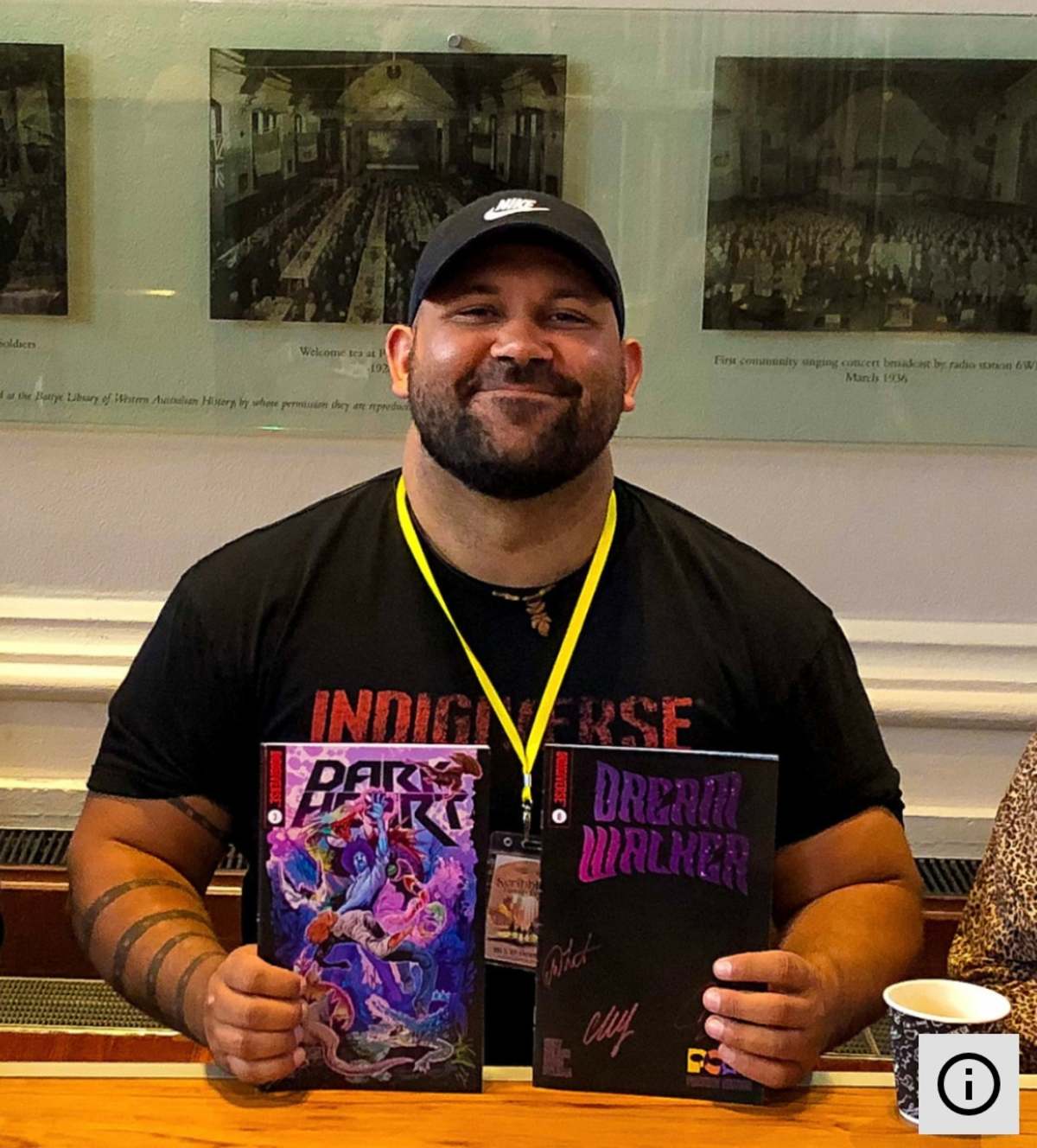 Picture of Scott Wilson, comic creator, holding two comics in his hands. 