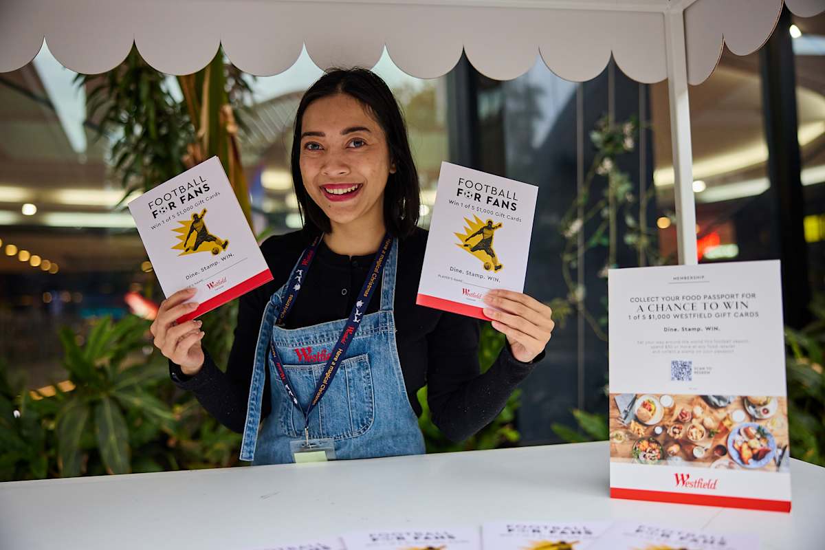 An image of a BX ambassador holding two food passports.