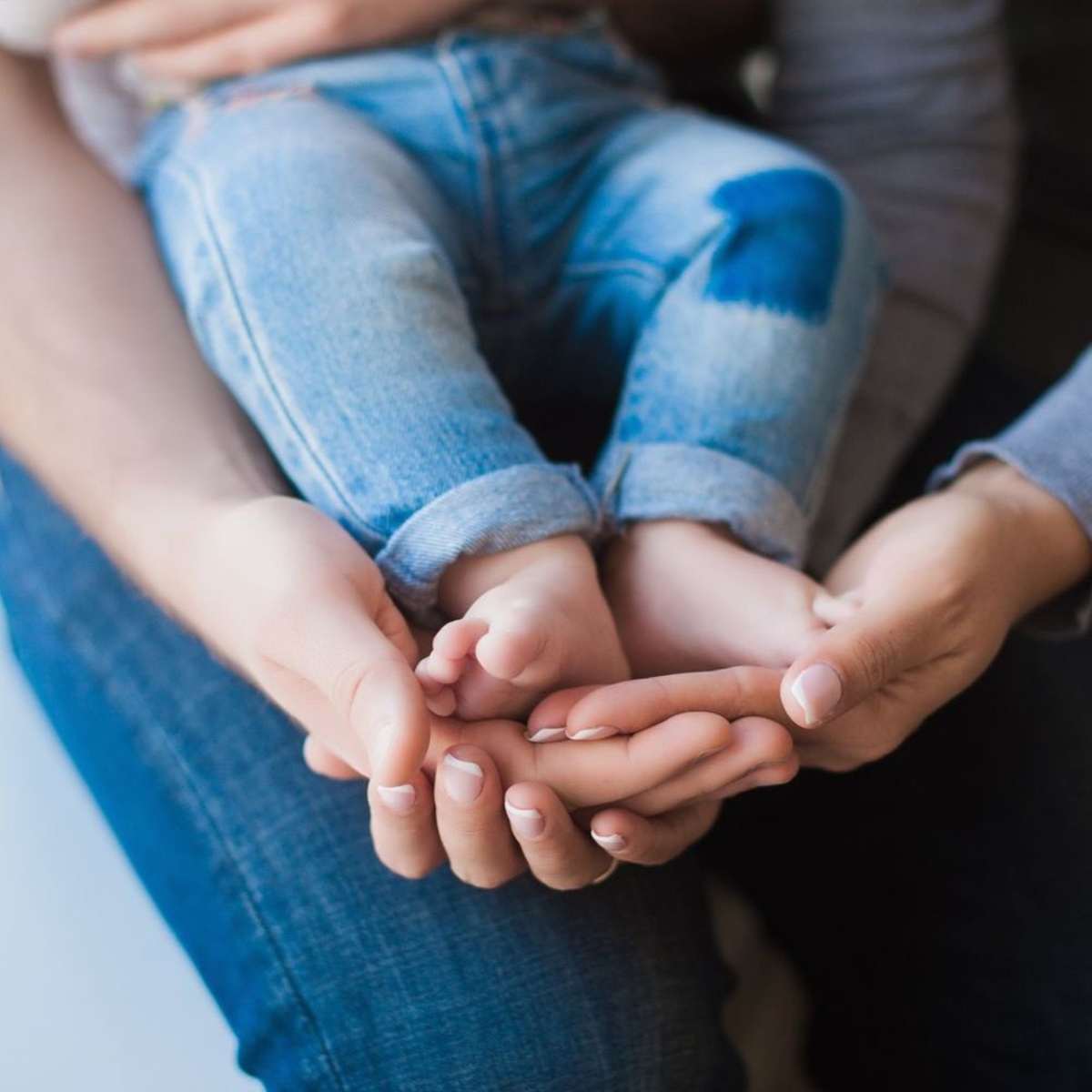 image of two hands cupping baby feet