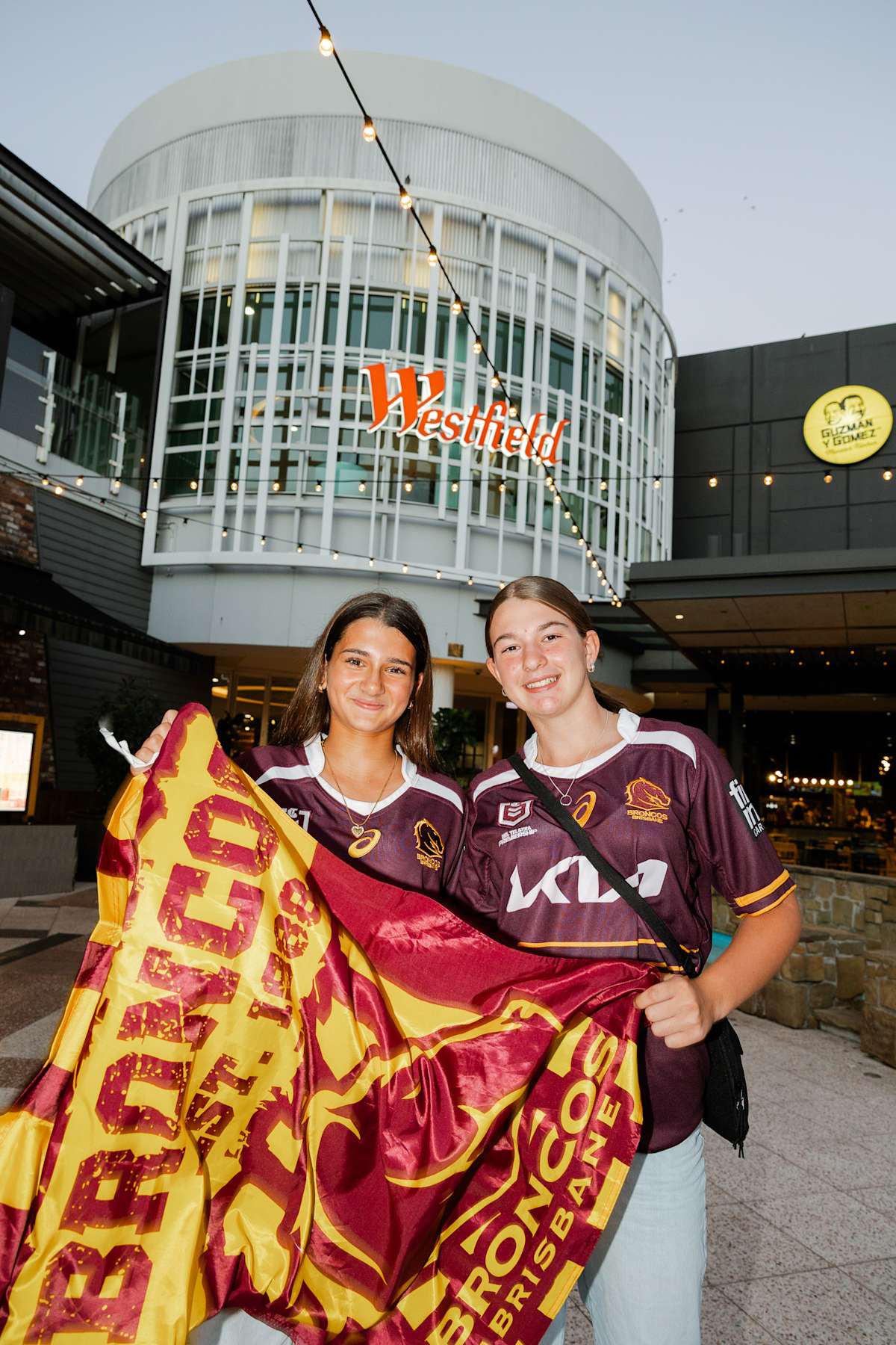 Two girls holDing Brisbane Broncos merch at Westfield