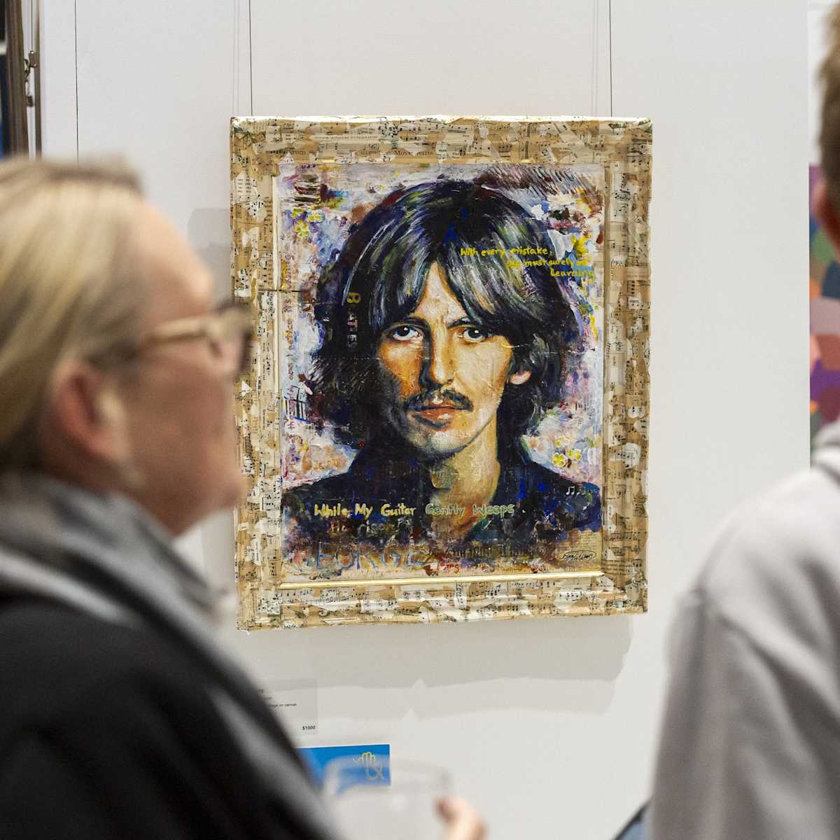 Image of two people viewing an artwork.