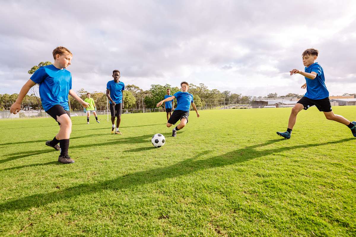 Teenagers playing soccer