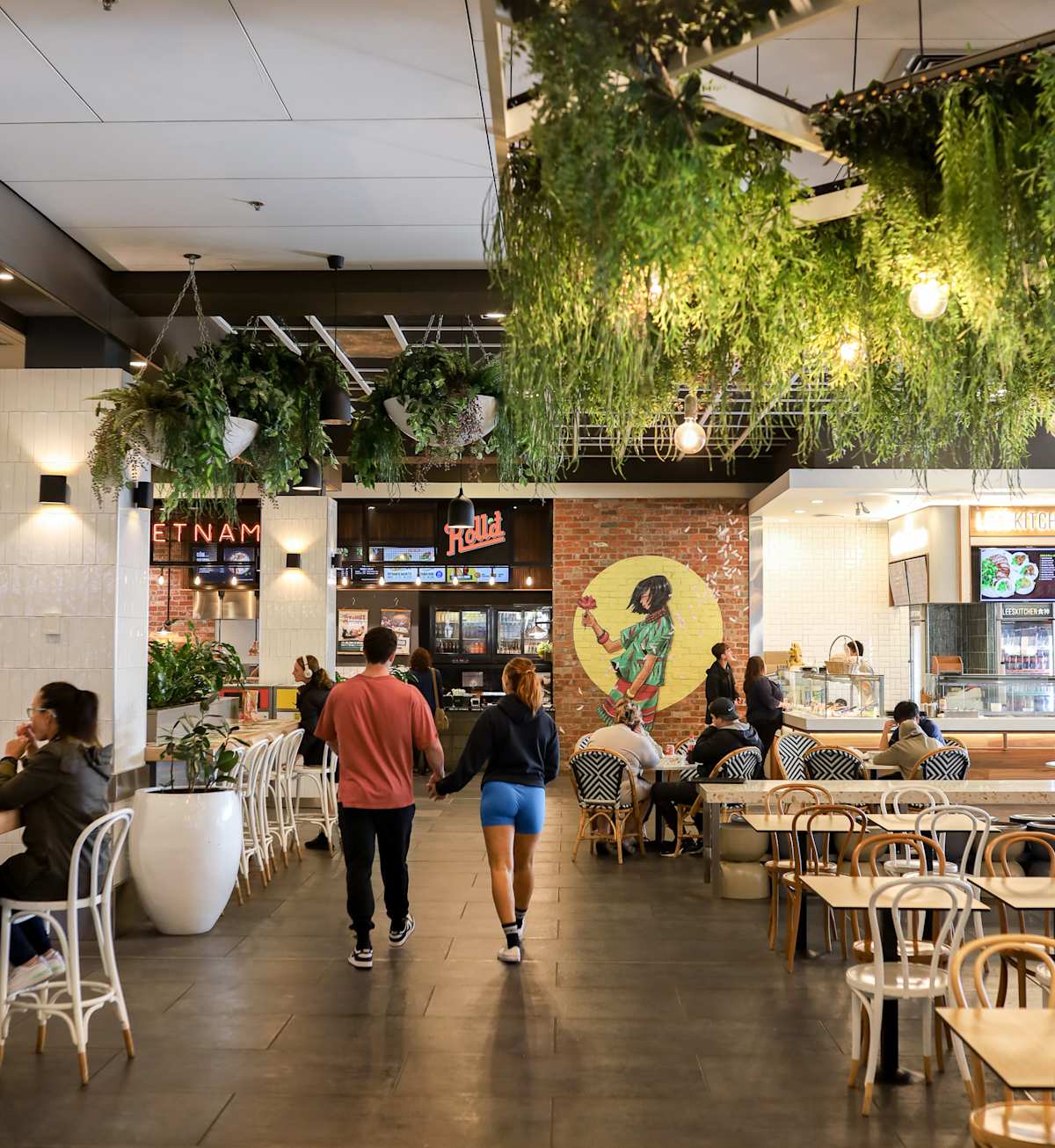 people walking through food court