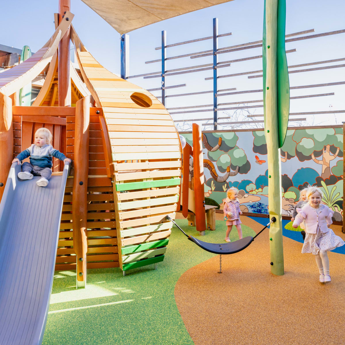 Wide shot of 4 kids playing in new gumnut playworld