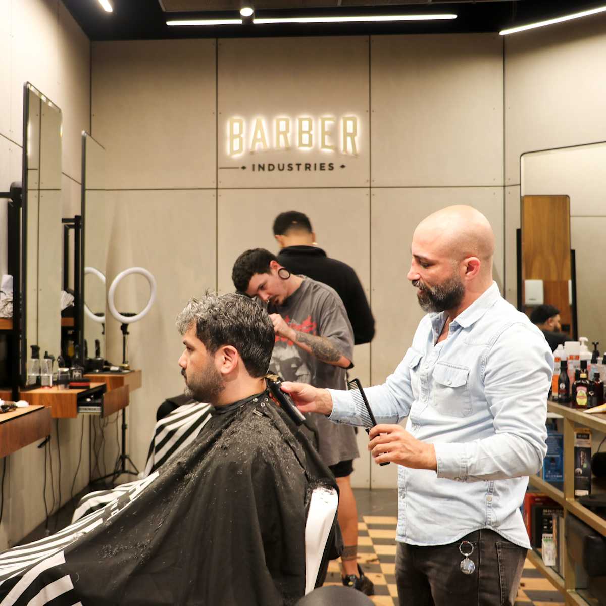 man getting his hair cut at Barber Industries
