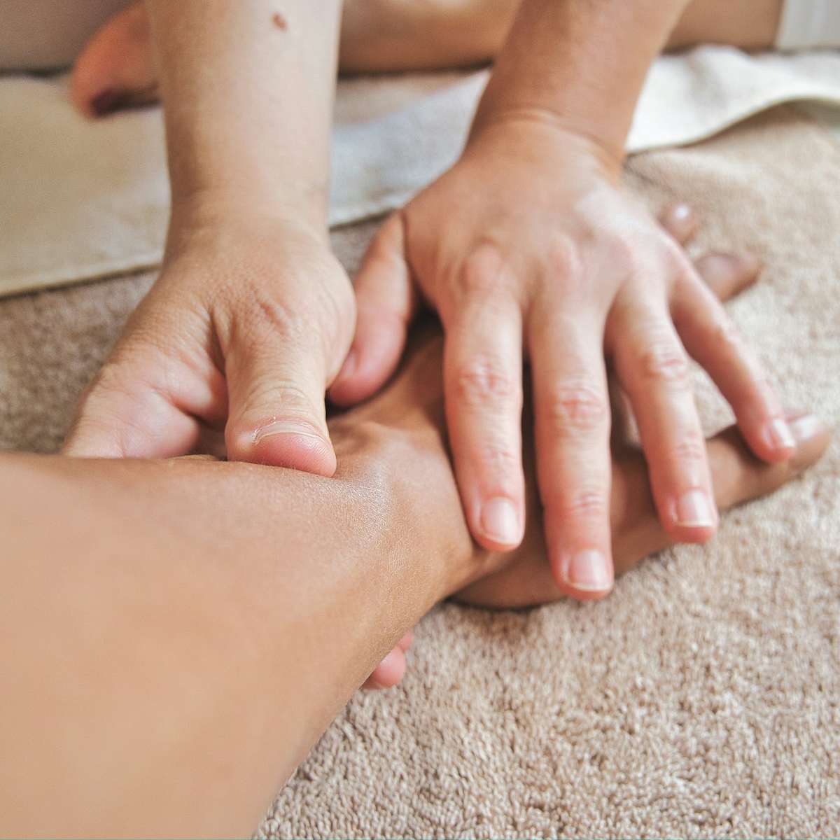 Arm being massaged by two hands
