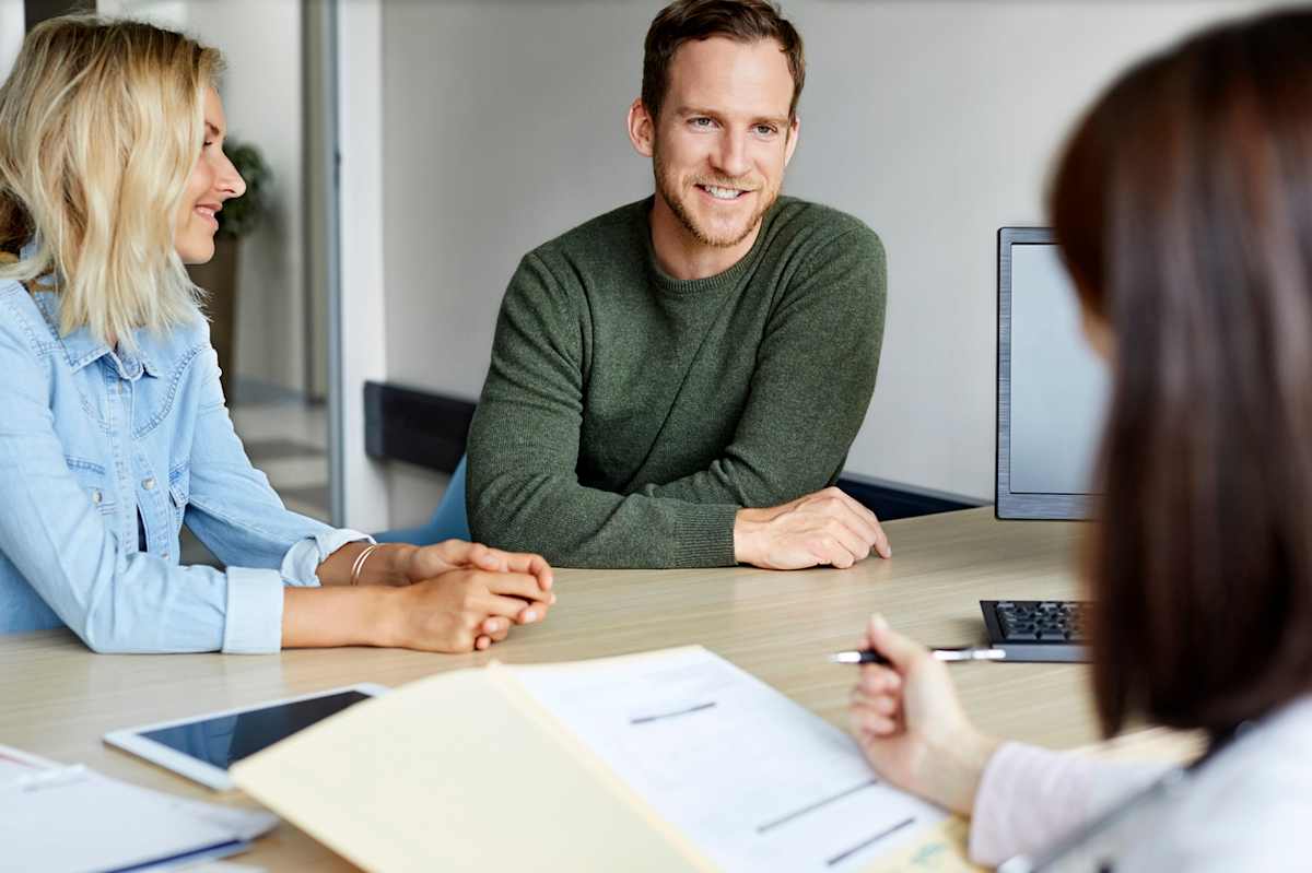 Couple sitting at a table with advisor