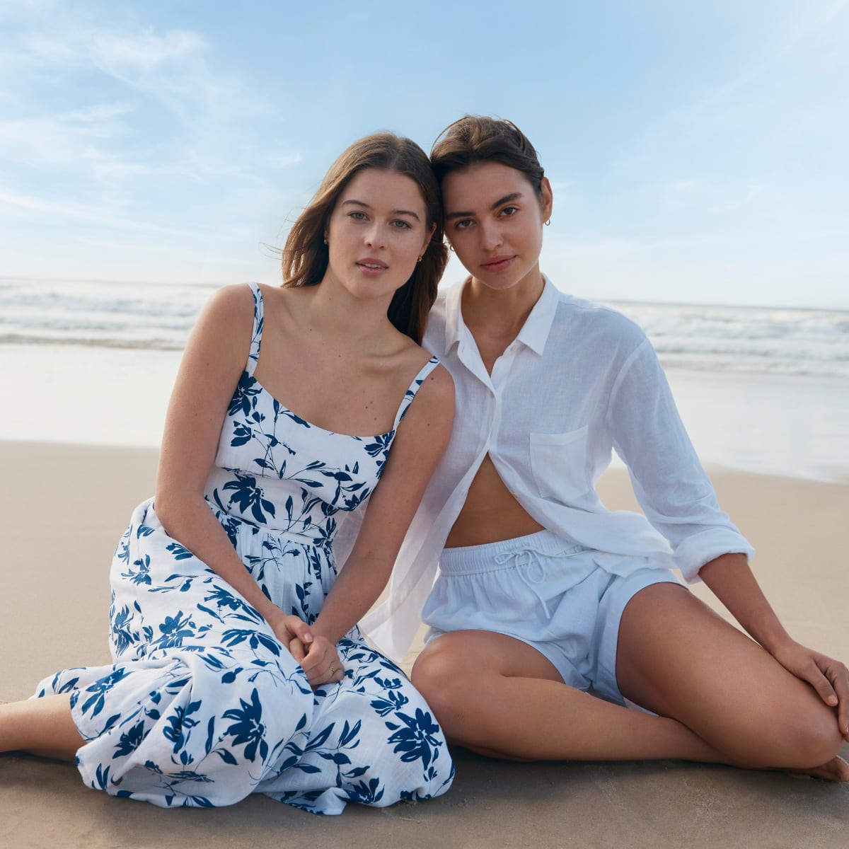 Two women in summery clothes on the beach