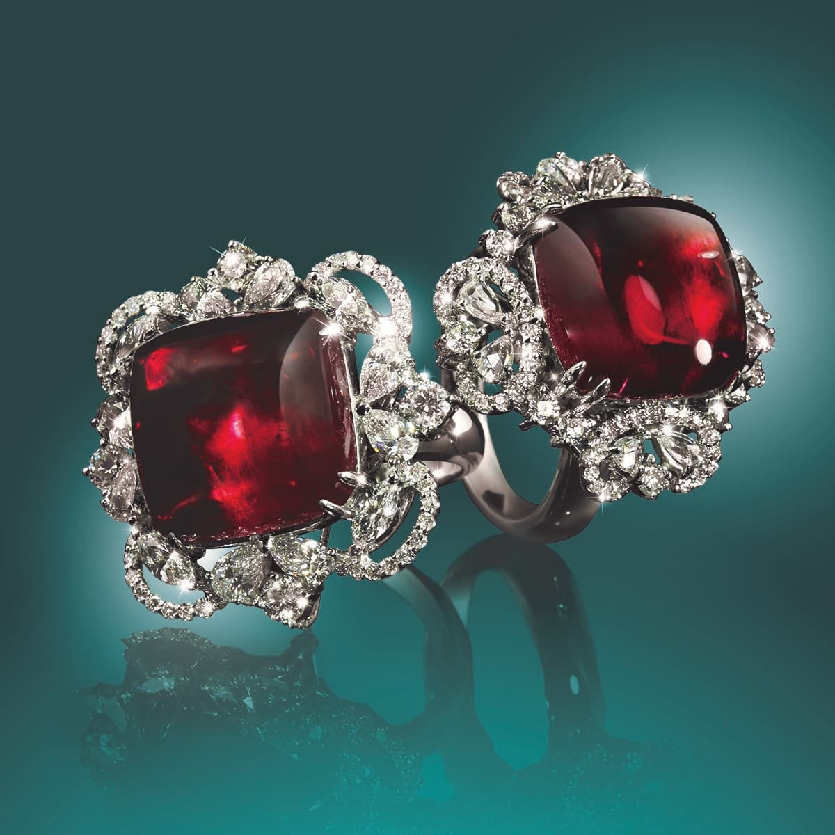 ID: Two ring with diamonds from Wamada Jewellery on a emerald green background