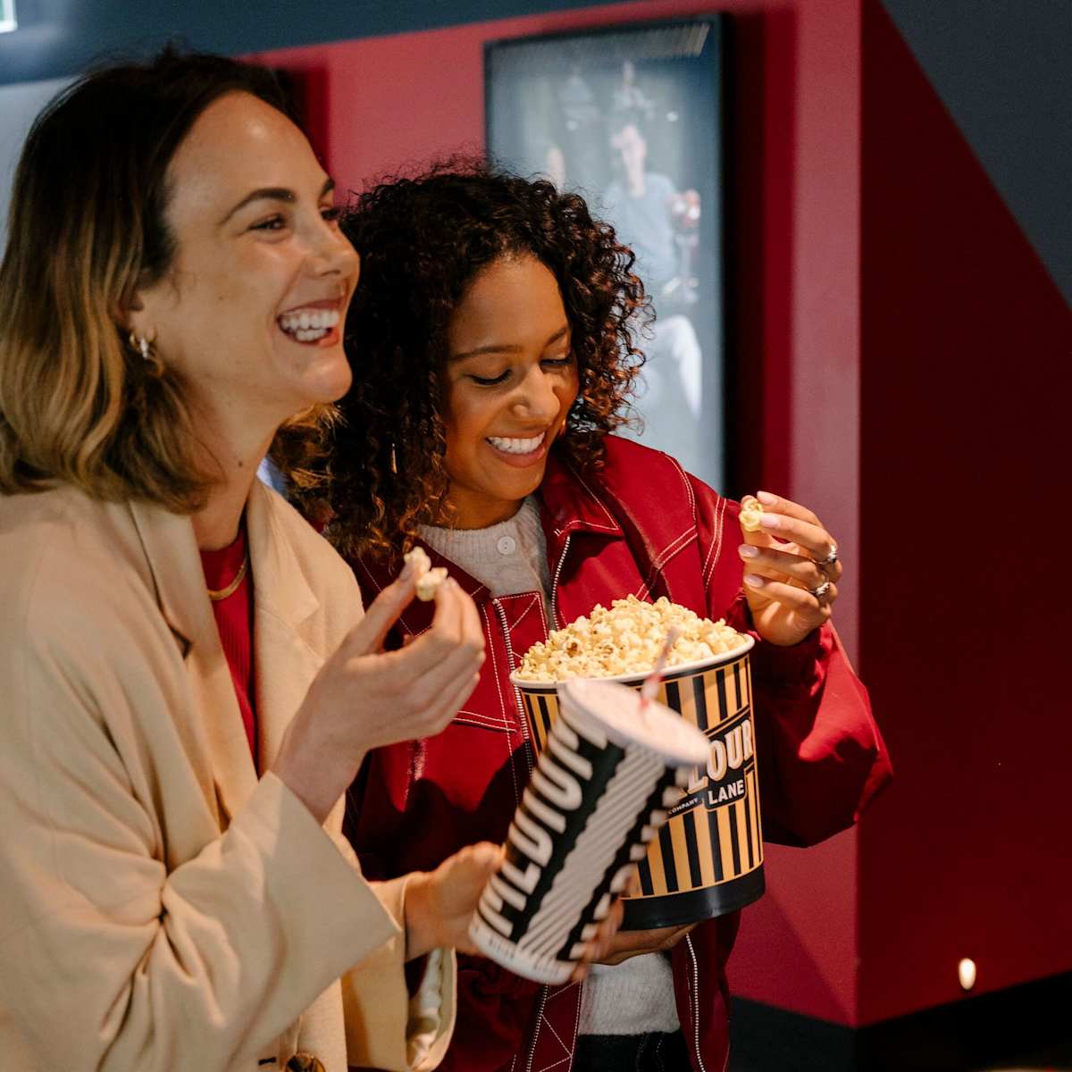 2 women eating popcorn