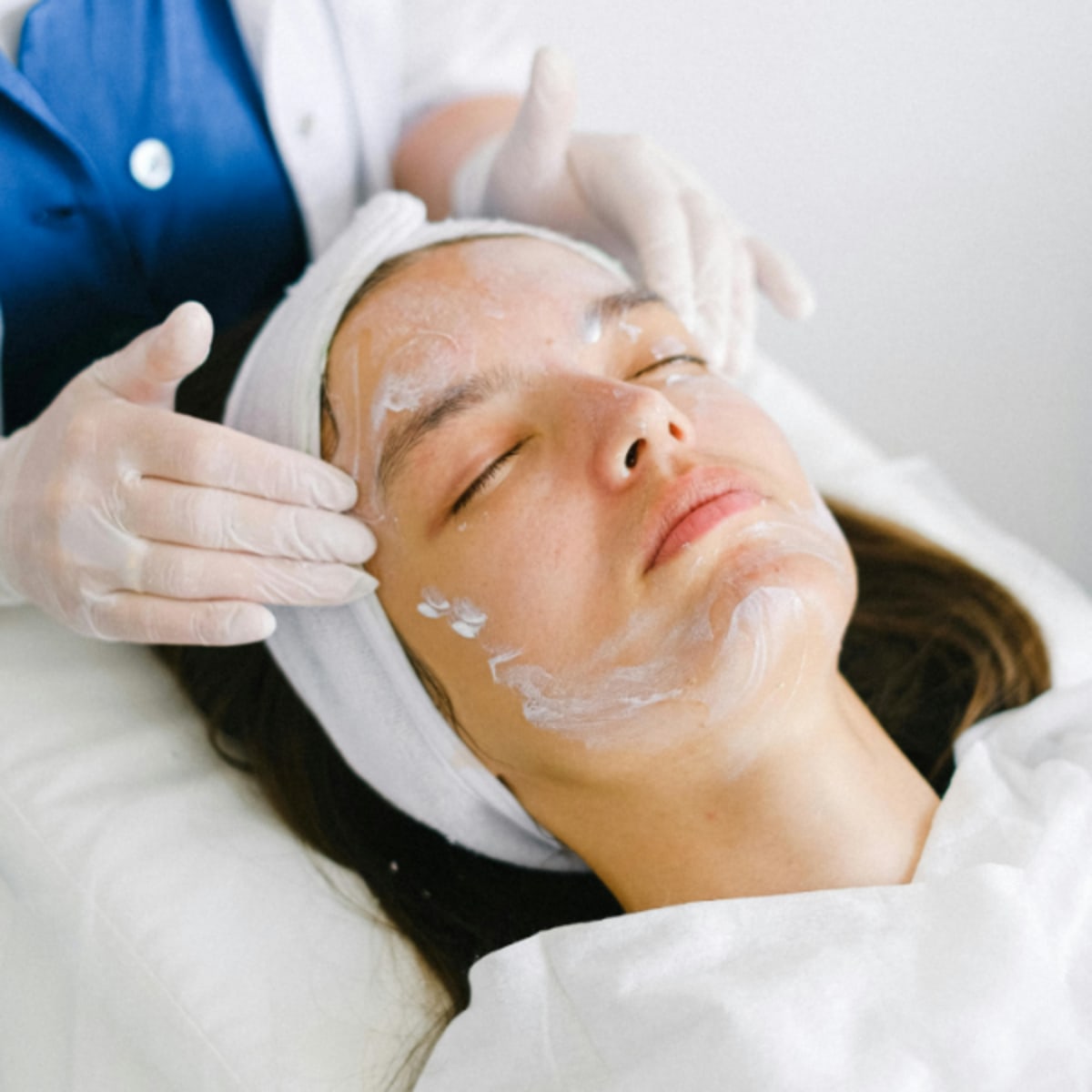 Image of woman receiving a facial treatment by a professional therapist