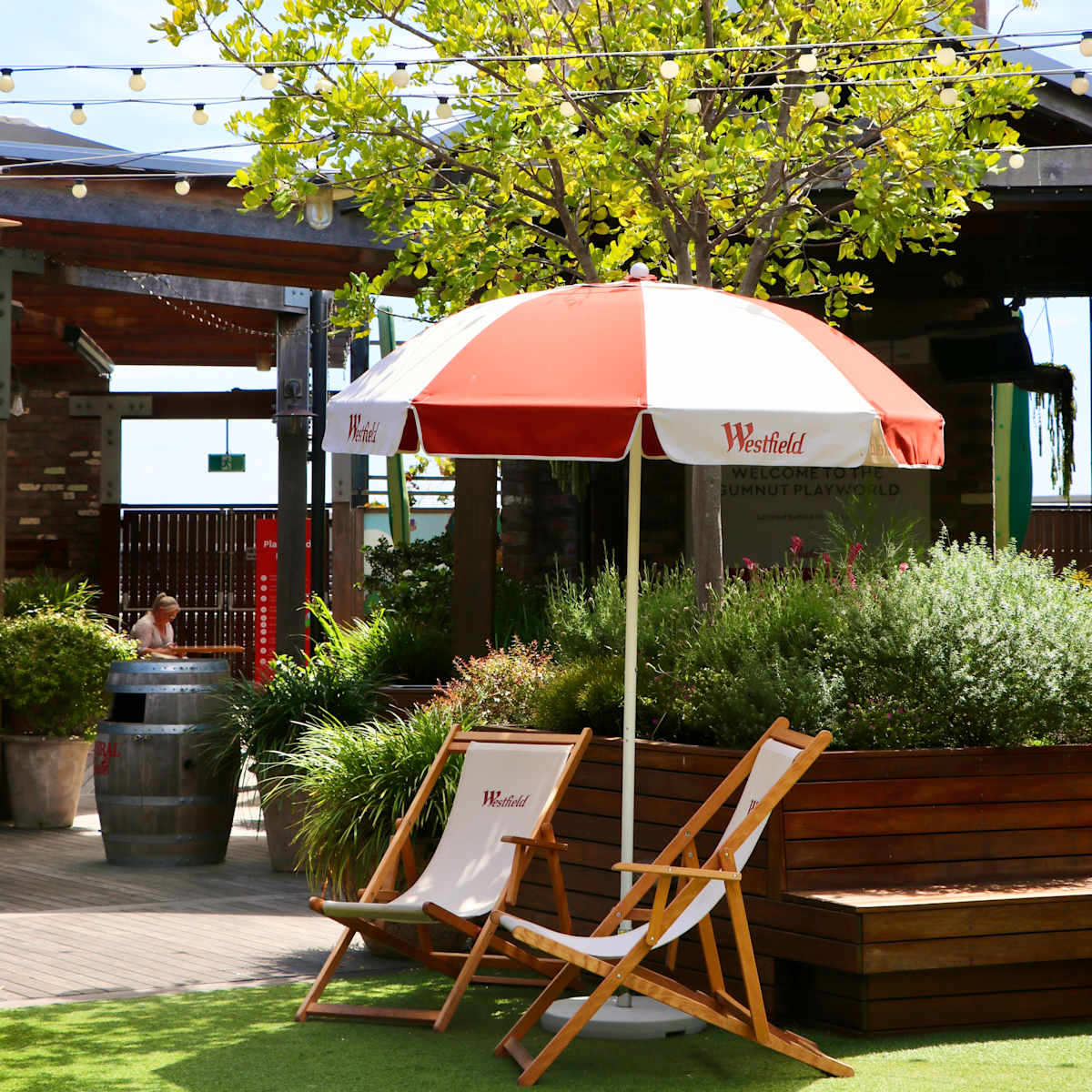 image of the deck chairs and umbrella on a sunny day on the rooftop