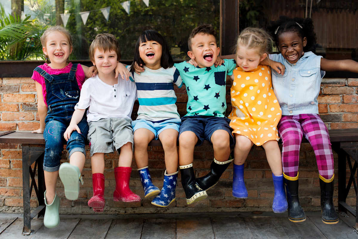 Children on a bench hugging