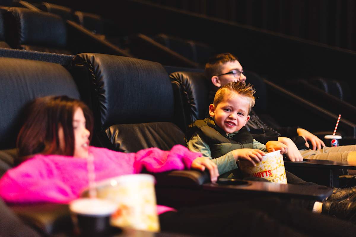 Kids enjoying popcorn at HOYTS Westfield Carousel.