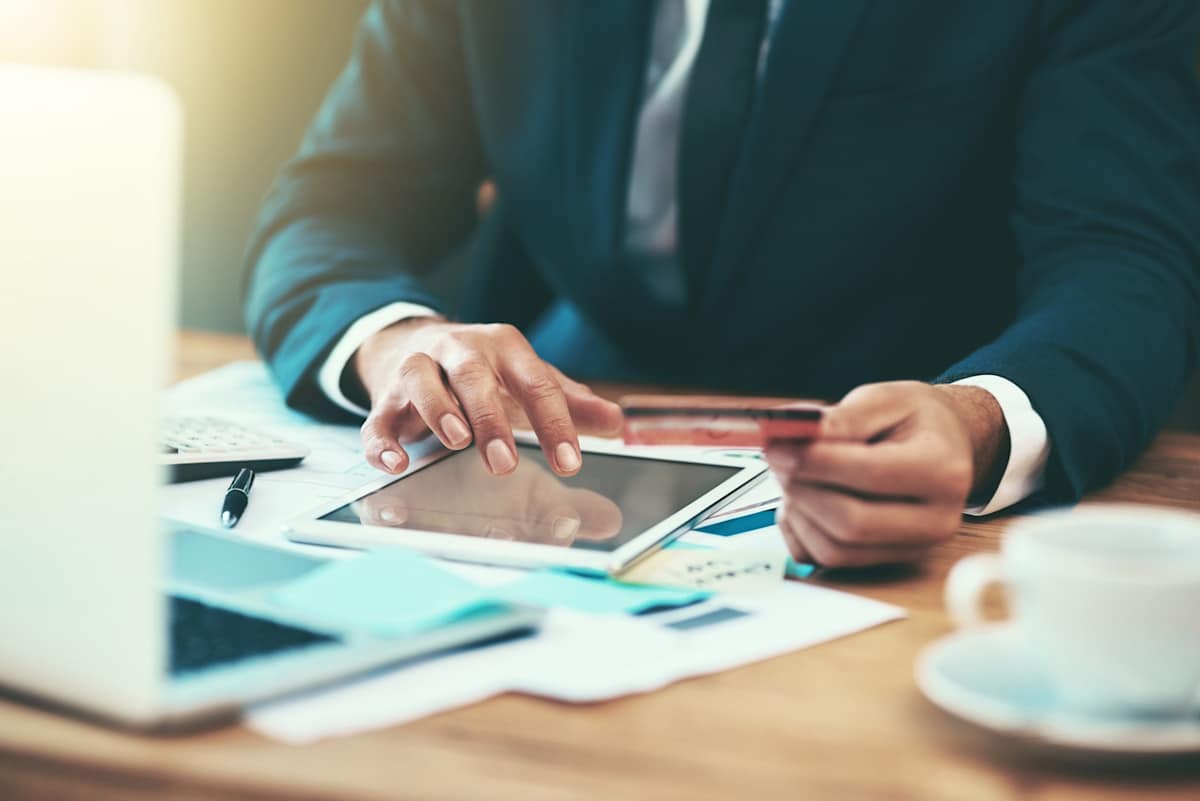 Man sitting at desk using iPad