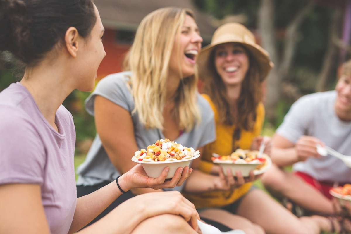 Friends laughing while eating