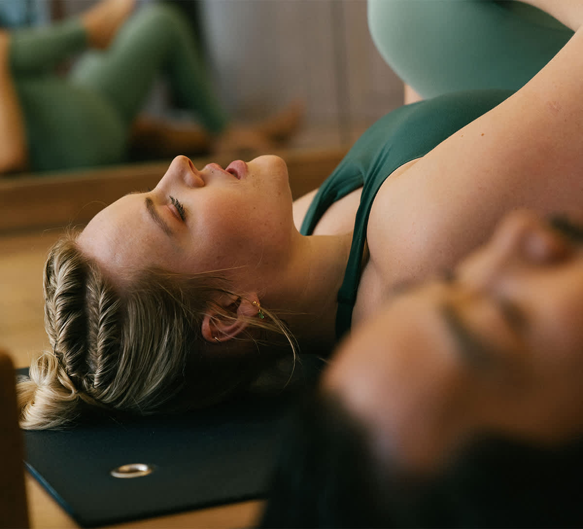 An image of a lady exercising in green outfit