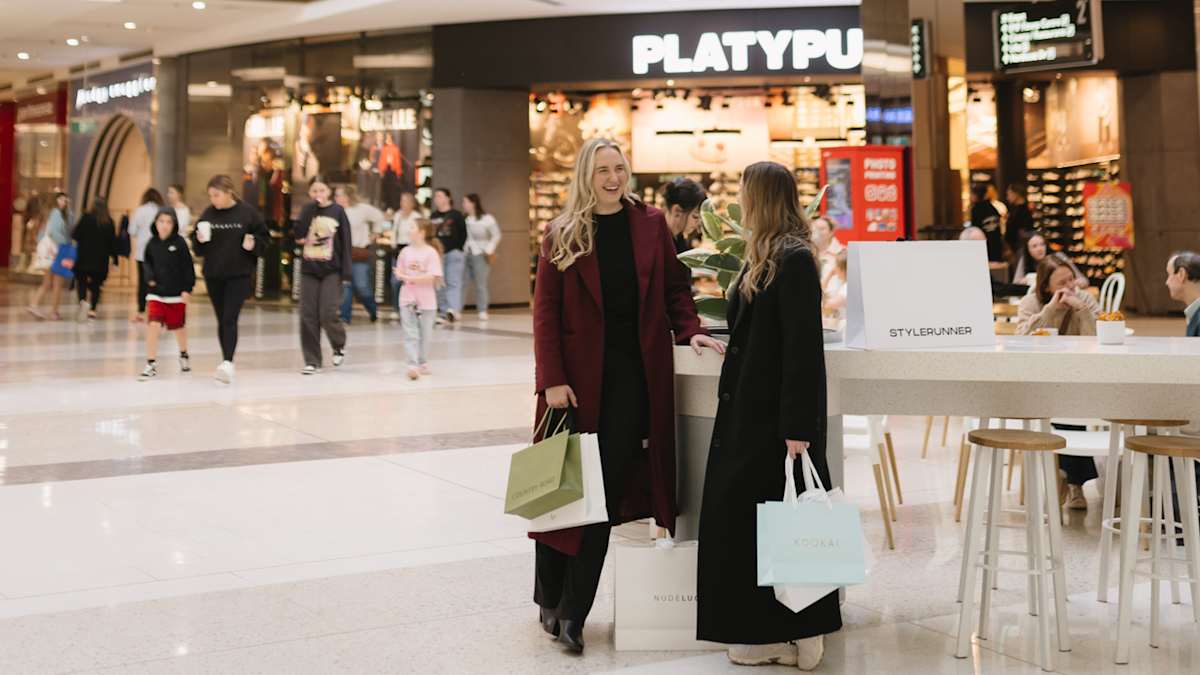 two women with multiple retailer shopping bags at westfield kotara