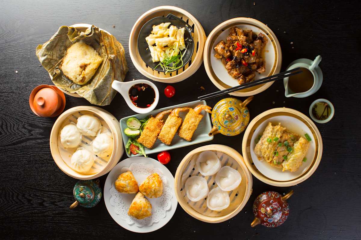 Mixed asian food on a black wooden table