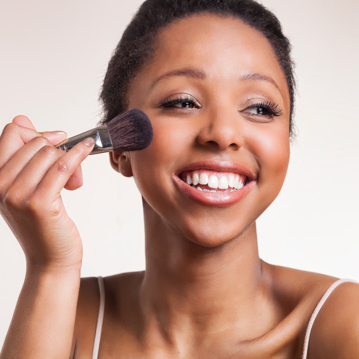 Woman doing makeup blush