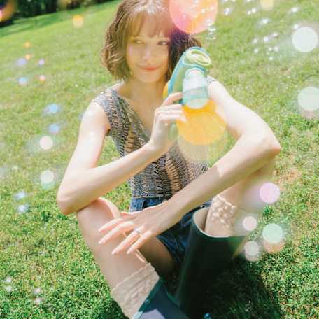 Woman sitting on the ground with bubbles