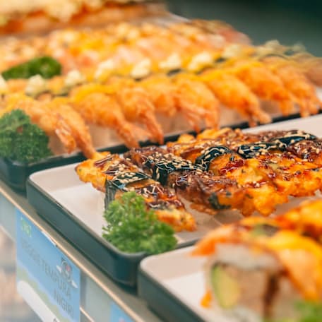 Sushi displayed in a cabinet.
