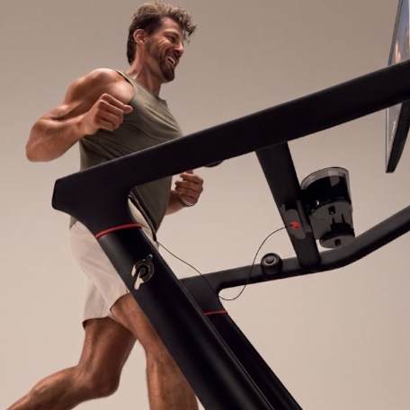 man, elated, running on peloton treadmill