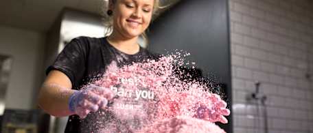 Lush team member making a pink bath bomb