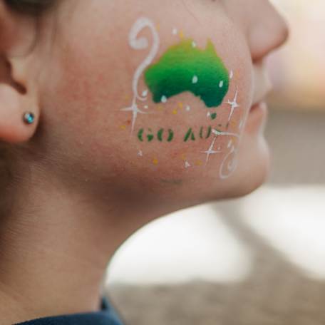 Child with Australia and 'Go Aus' painted on their cheek