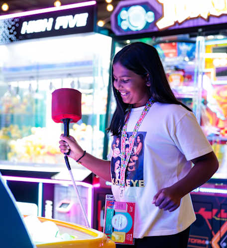 An image of a girl at iPlay with a Kids Pass. 