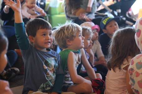 Kids sitting down listening.