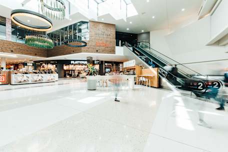 wide shotinside centre near rooftop escalators